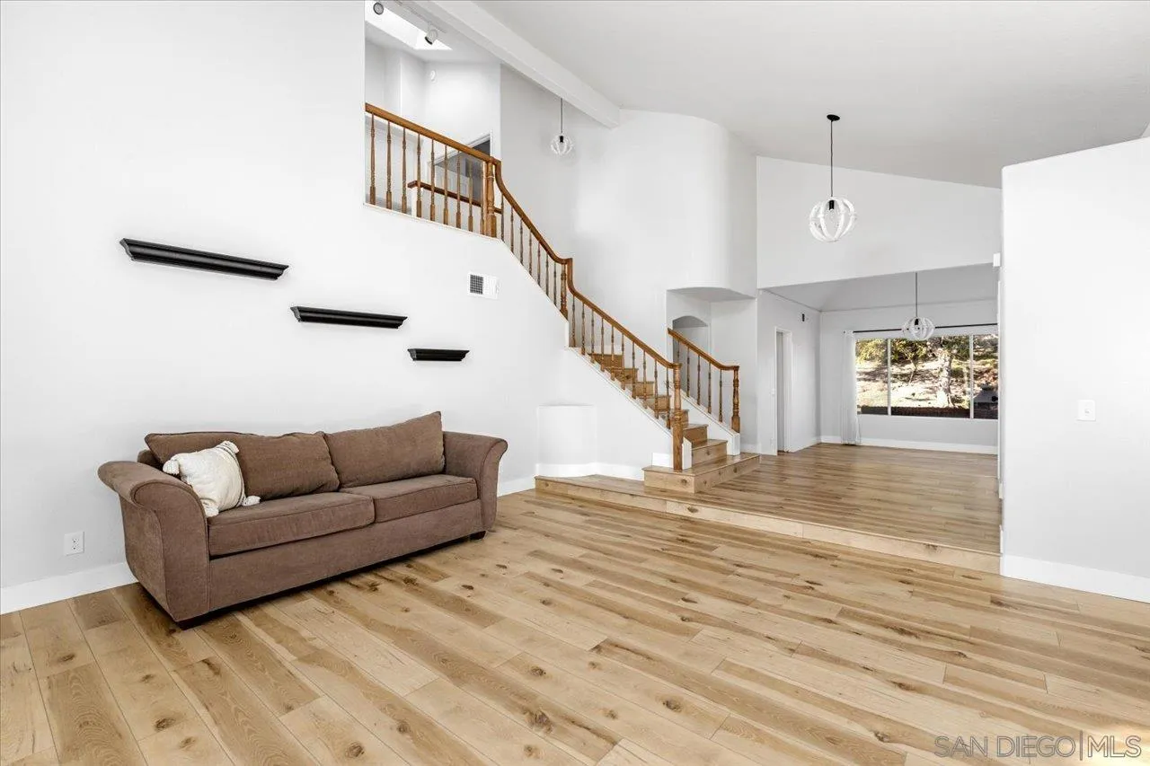 331 Vista Marazul Oceanside, CA 92057 - Photo 9 of 27 a living room with furniture and stairs with wooden floor