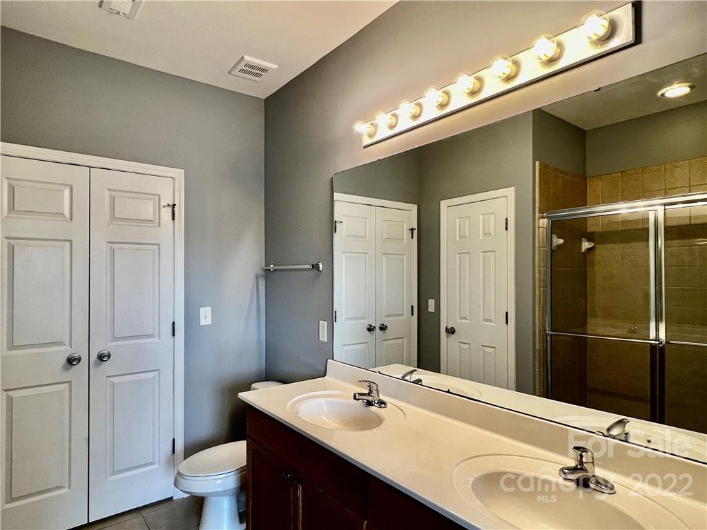 18742 Nautical Drive, Unit 305 Cornelius, NC 28031 - Photo 15 of 30 a bathroom with a sink vanity and a mirror