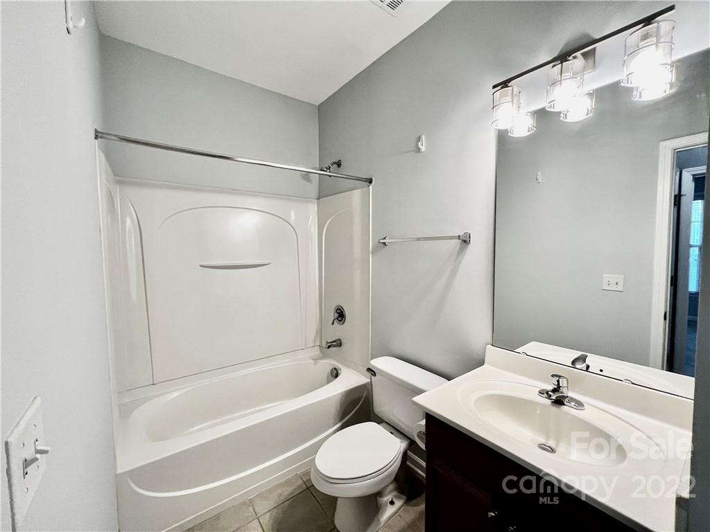 18742 Nautical Drive, Unit 305 Cornelius, NC 28031 - Photo 18 of 30 a bathroom with a sink a toilet and a large mirror