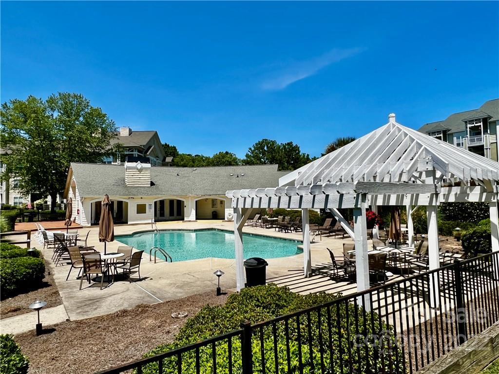 18742 Nautical Drive, Unit 305 Cornelius, NC 28031 - Photo 24 of 30 a view of a house with wooden deck and furniture