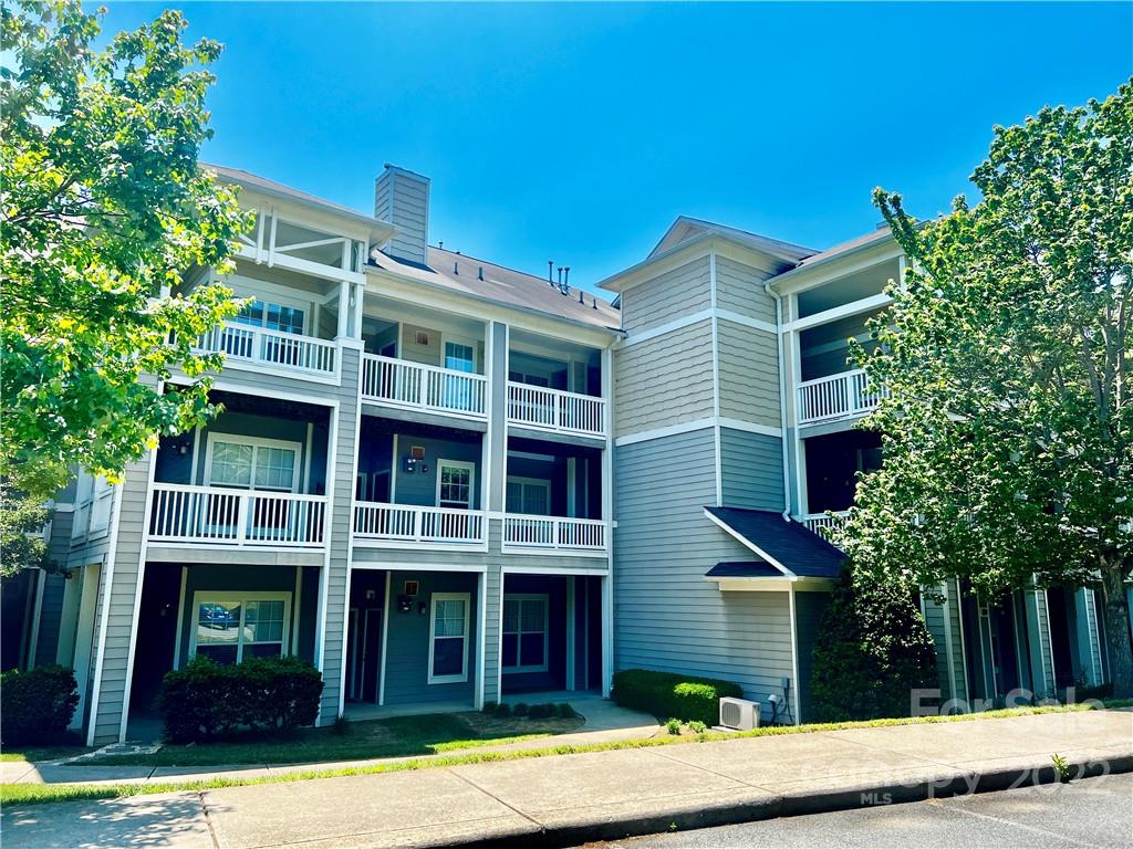 18742 Nautical Drive, Unit 305 Cornelius, NC 28031 - Photo 26 of 30 a front view of a house with a yard
