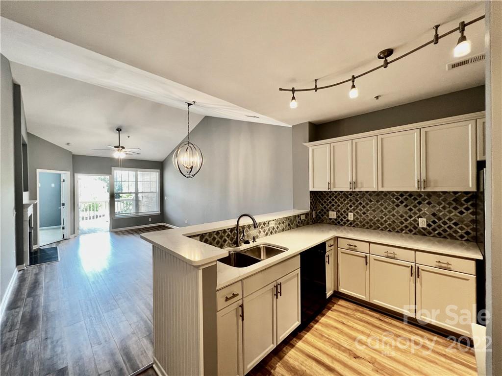 18742 Nautical Drive, Unit 305 Cornelius, NC 28031 - Photo 5 of 30 a kitchen with a stove a sink and a refrigerator