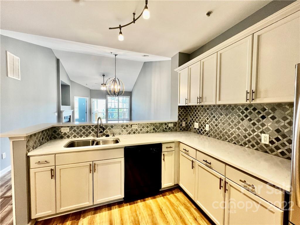 18742 Nautical Drive, Unit 305 Cornelius, NC 28031 - Photo 6 of 30 a kitchen with a sink stove and cabinets