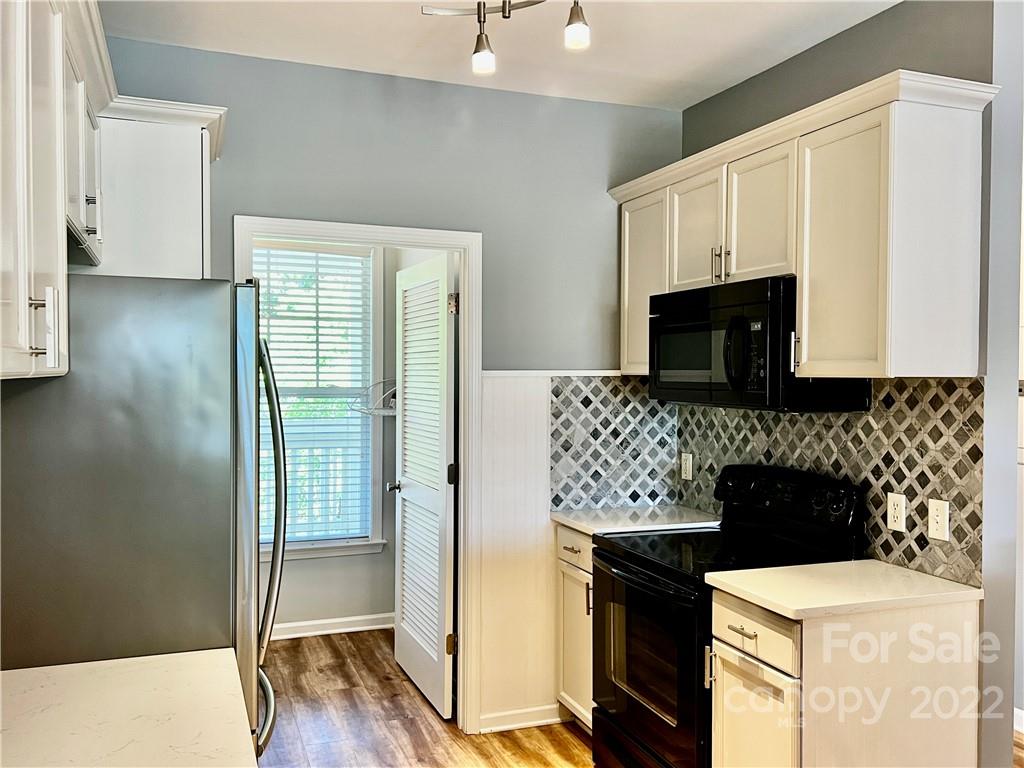 18742 Nautical Drive, Unit 305 Cornelius, NC 28031 - Photo 10 of 30 a kitchen with a sink and a stove top oven