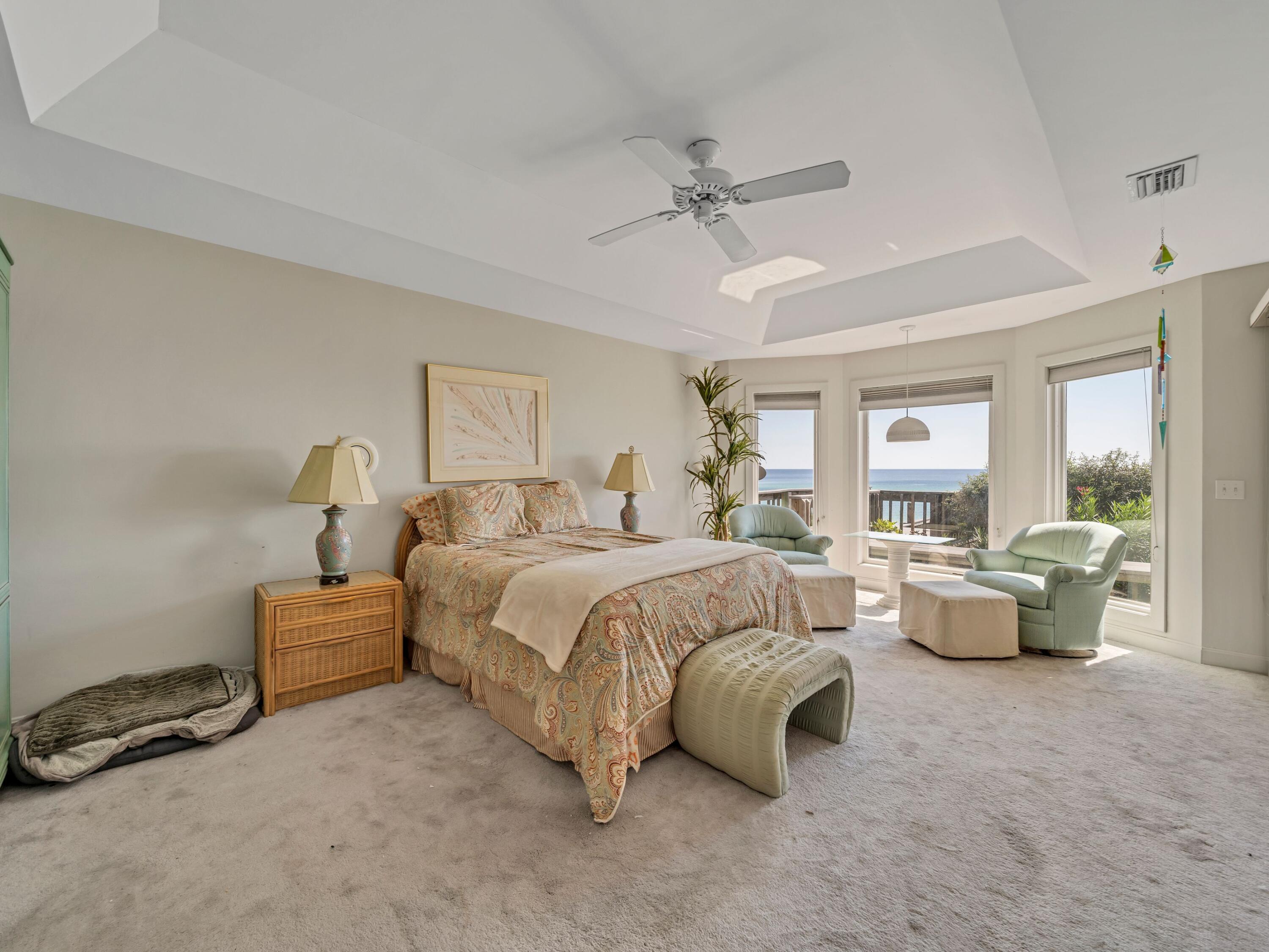 250 Sand Cliffs Drive Inlet Beach, FL 32461 - Photo 17 of 35 a spacious bedroom with a bed and ceiling fan