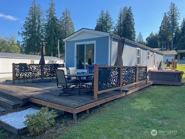 a view of a chair and table in backyard of the house