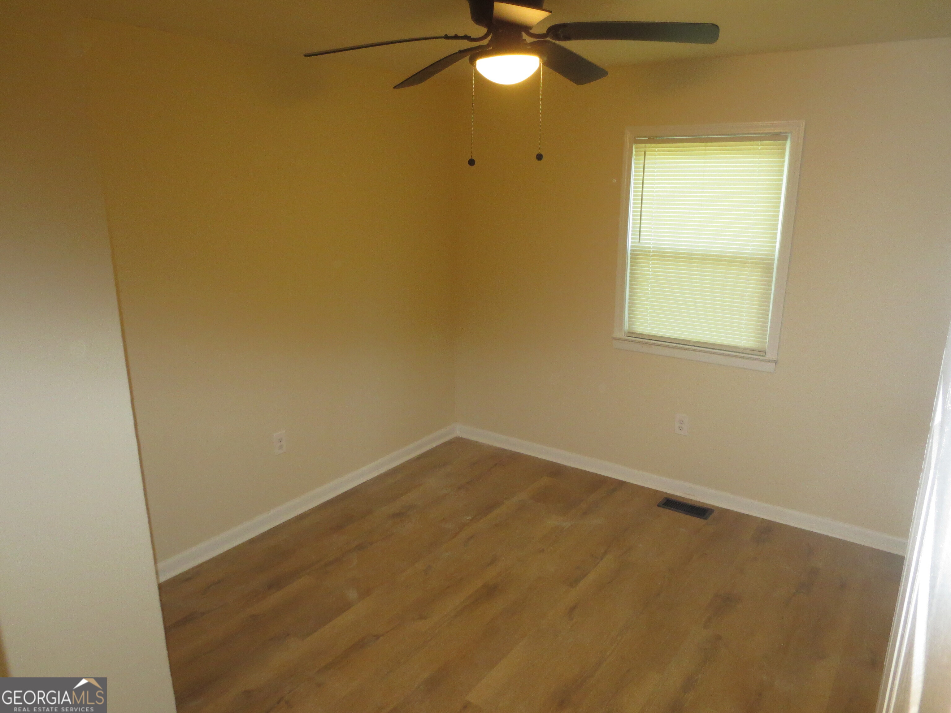 141 Wall Street Warner Robins, GA 31088 - Photo 10 of 16 an empty room with a window and a fan