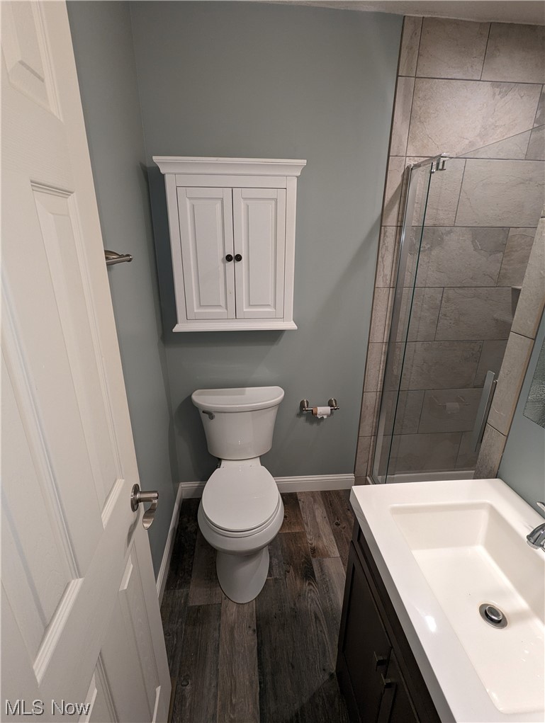 53154 Key Bellaire Road Bellaire, OH 43906 - Photo 16 of 43 Bathroom with vanity, toilet, walk in shower, and hardwood / wood-style flooring