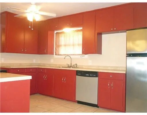 a kitchen with granite countertop a sink and cabinets