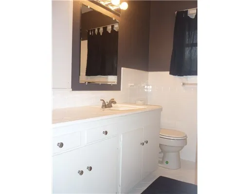 a bathroom with a sink toilet and mirror