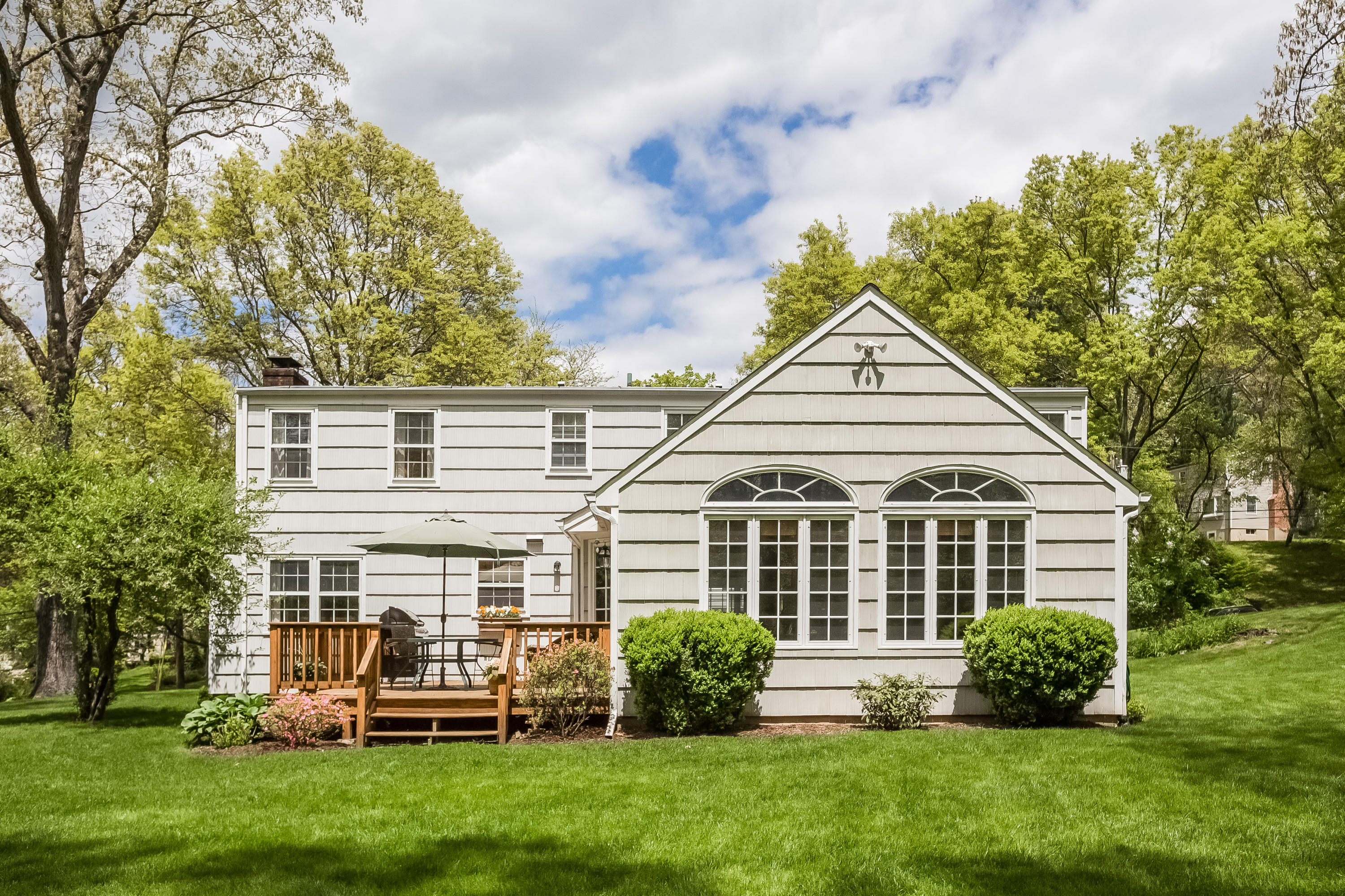 7 Briar Brae Road Darien, CT 06820 - Photo 30 of 35 a front view of a house with a yard and green space