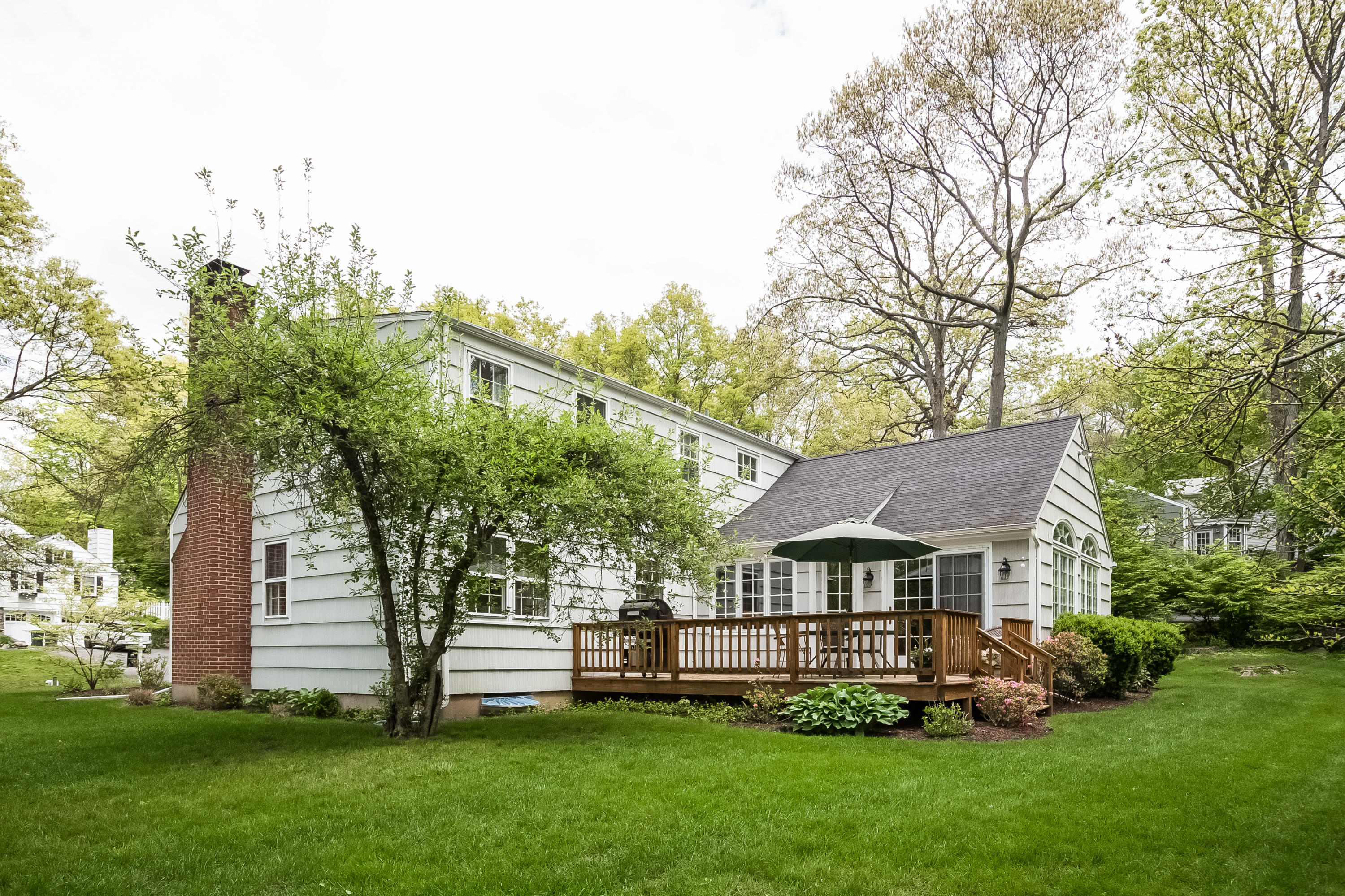 7 Briar Brae Road Darien, CT 06820 - Photo 31 of 35 a front view of a house with a garden and trees