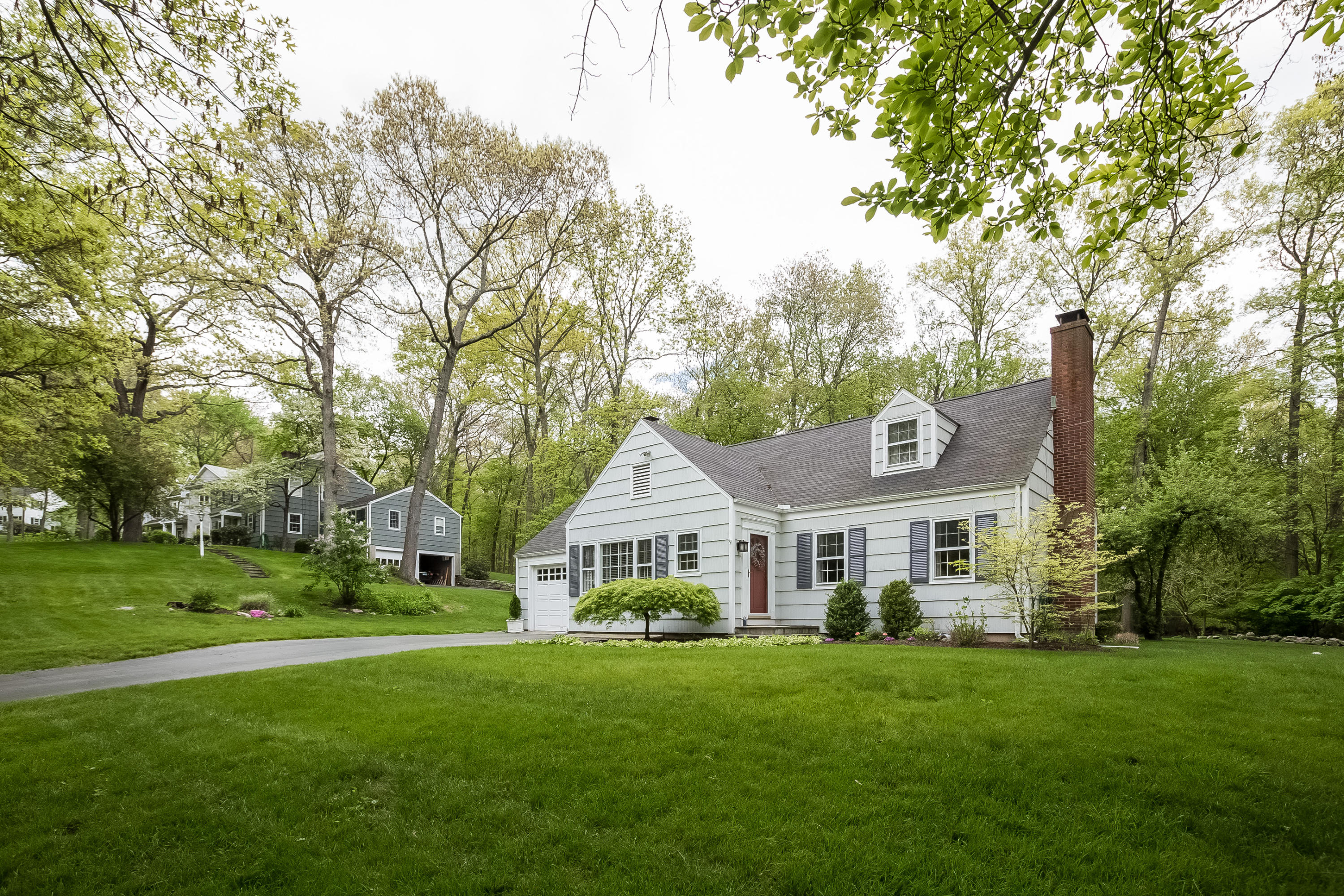 7 Briar Brae Road Darien, CT 06820 - Photo 4 of 35 a white house with a big yard and large trees
