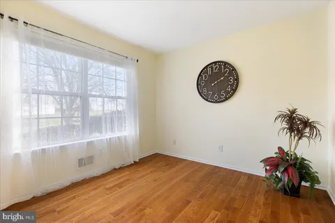 a view of a room with wooden floor and entryway