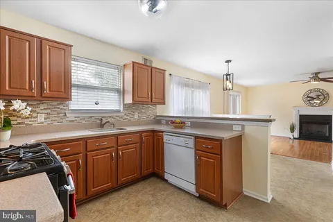 a kitchen with stainless steel appliances granite countertop a stove a sink dishwasher and a microwave oven with cabinets