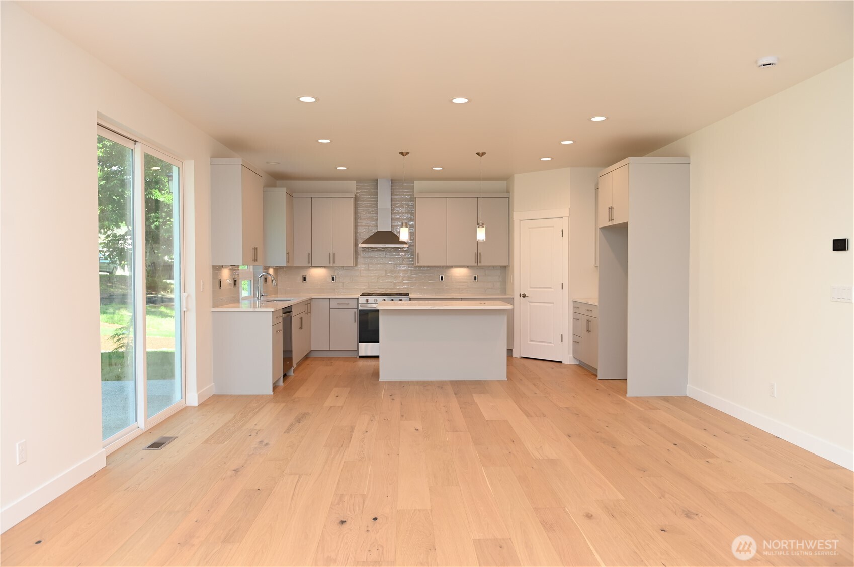 1323 Roland Street Bellingham, WA 98229 - Photo 7 of 16 a large white kitchen with a refrigerator a sink and white cabinets