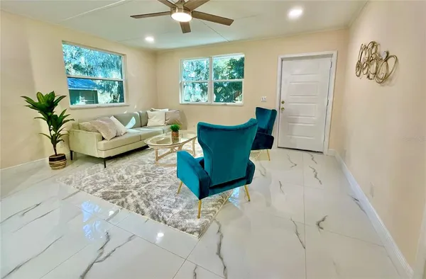 a living room with furniture and a large window