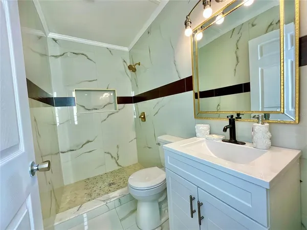 a bathroom with a sink toilet and shower