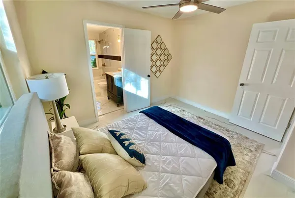 a bed sitting in a bedroom and chair