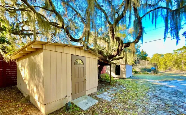 a view of a house with a tree beside of it