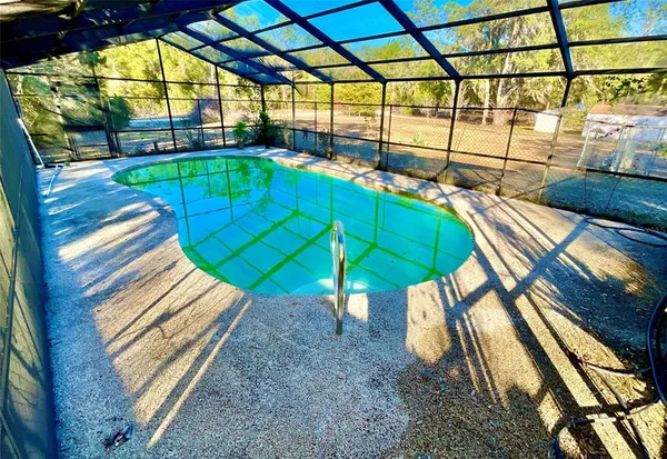 a view of a backyard with a patio and a garden