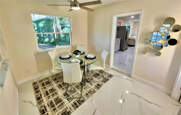 a dining room with furniture and wooden floor