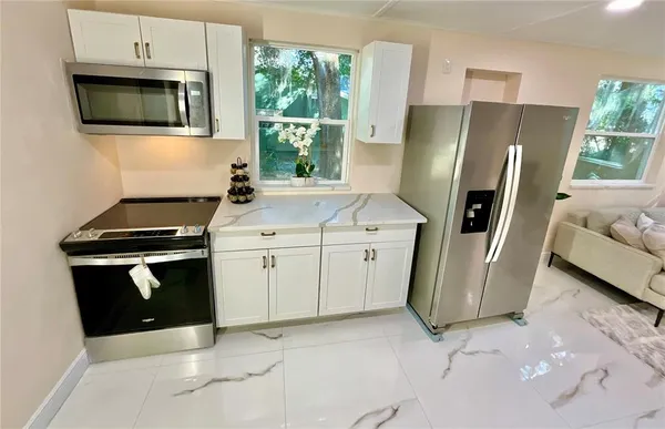 a kitchen with appliances a sink and a stove