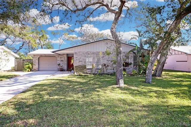 a house with swimming pool in front of it