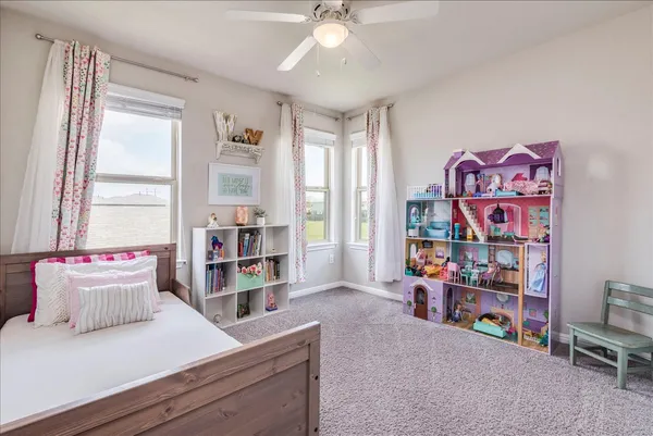 a living room with furniture and a book shelf
