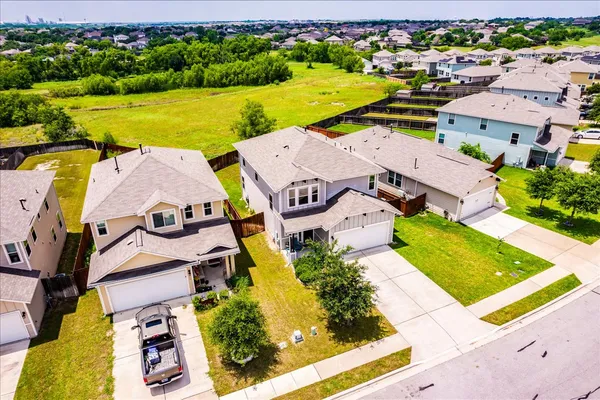 an aerial view of residential houses with outdoor space and river