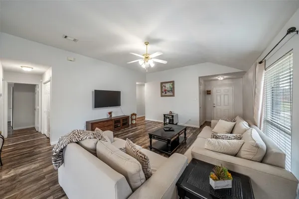 a living room with furniture and a flat screen tv