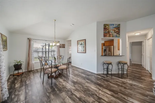 a view of a dining room with furniture and wooden floor