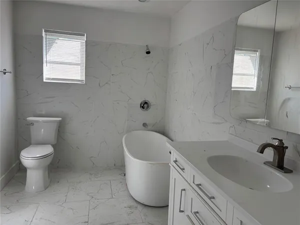 a bathroom with a sink toilet and tub