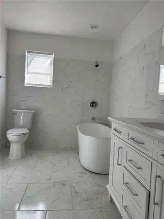 a bathroom with a sink a toilet and a bathtub