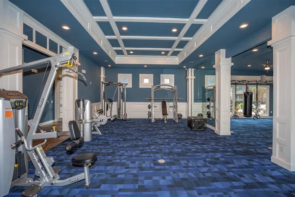 a view of pool with lawn chairs and large trees