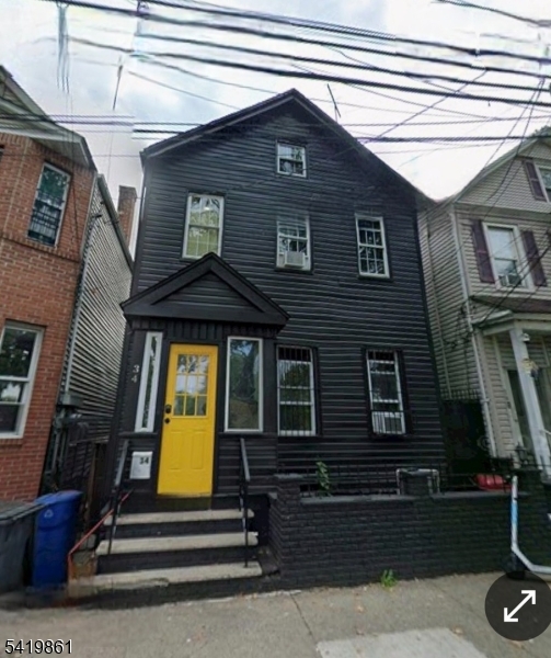 34 Duryea Street Newark, NJ 07103 - Photo 1 of 15 a front view of a house with a garden