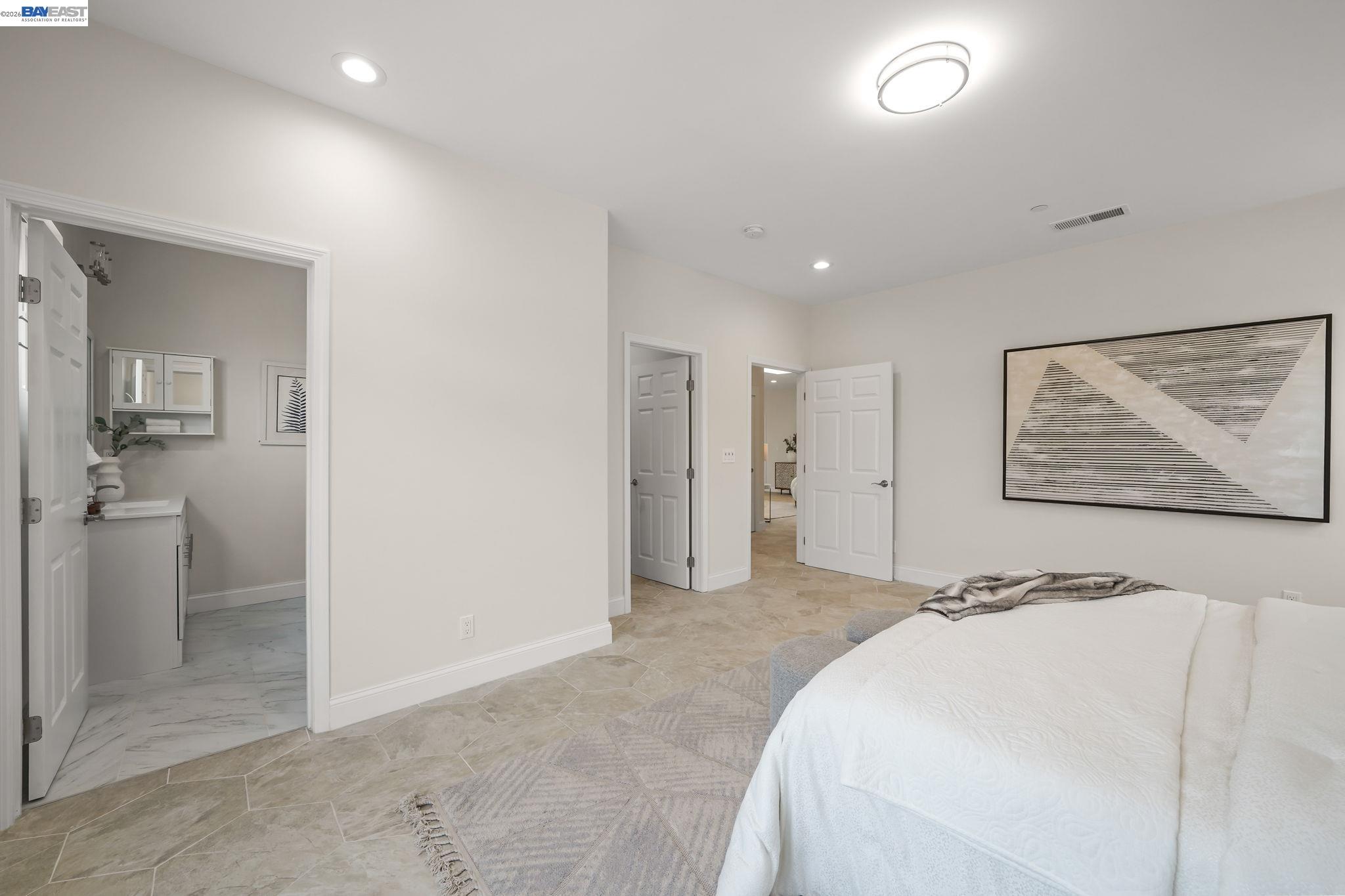 40772 Blacow Road Fremont, CA 94538 - Photo 28 of 40 a view of a bedroom with wooden floor and a bathroom