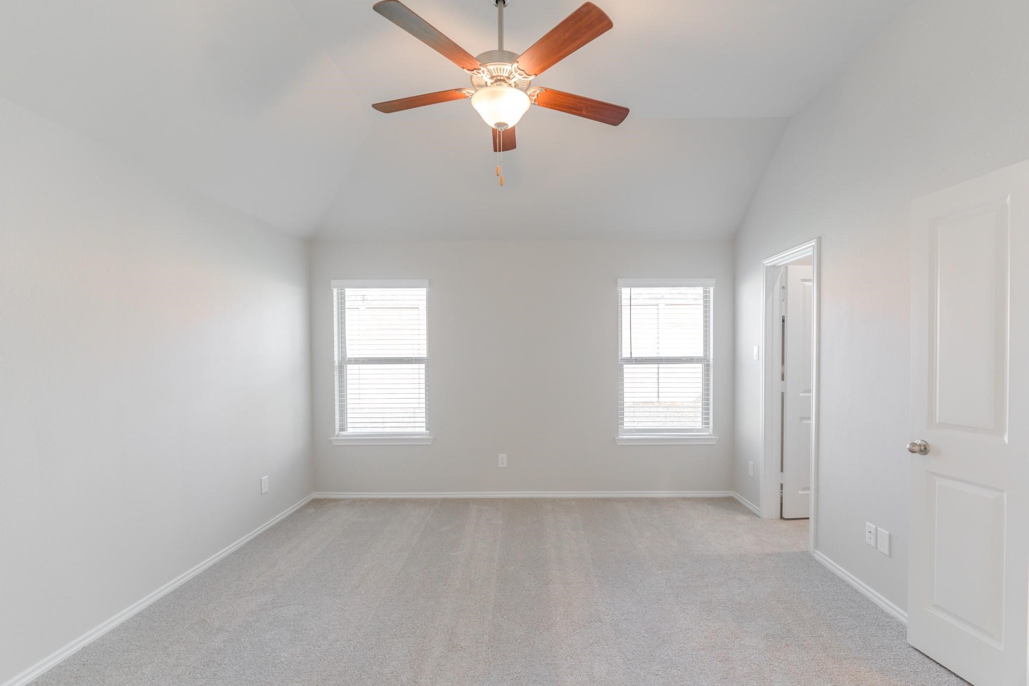 7427 Caprock Cyn Lane Porter, TX 77365 - Photo 11 of 21 an empty room with windows and fan