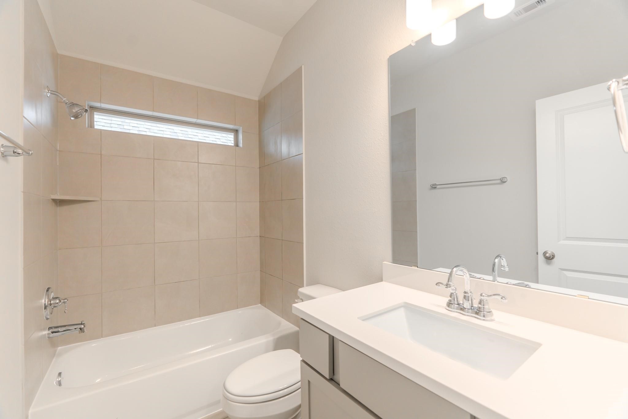 7427 Caprock Cyn Lane Porter, TX 77365 - Photo 13 of 21 a bathroom with a bathtub shower sink vanity mirror and toilet