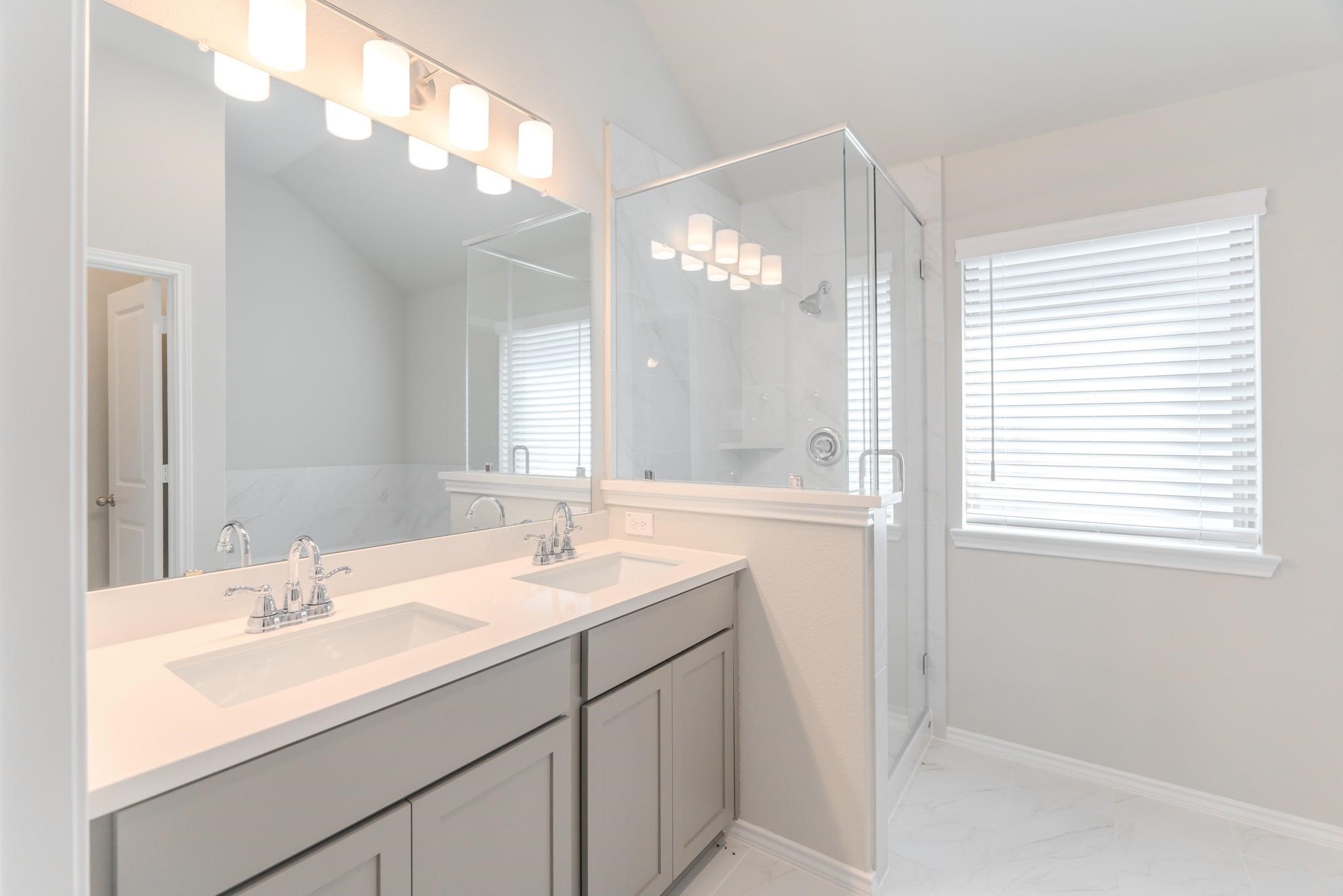 7427 Caprock Cyn Lane Porter, TX 77365 - Photo 19 of 21 a bathroom with a double vanity sink and a mirror