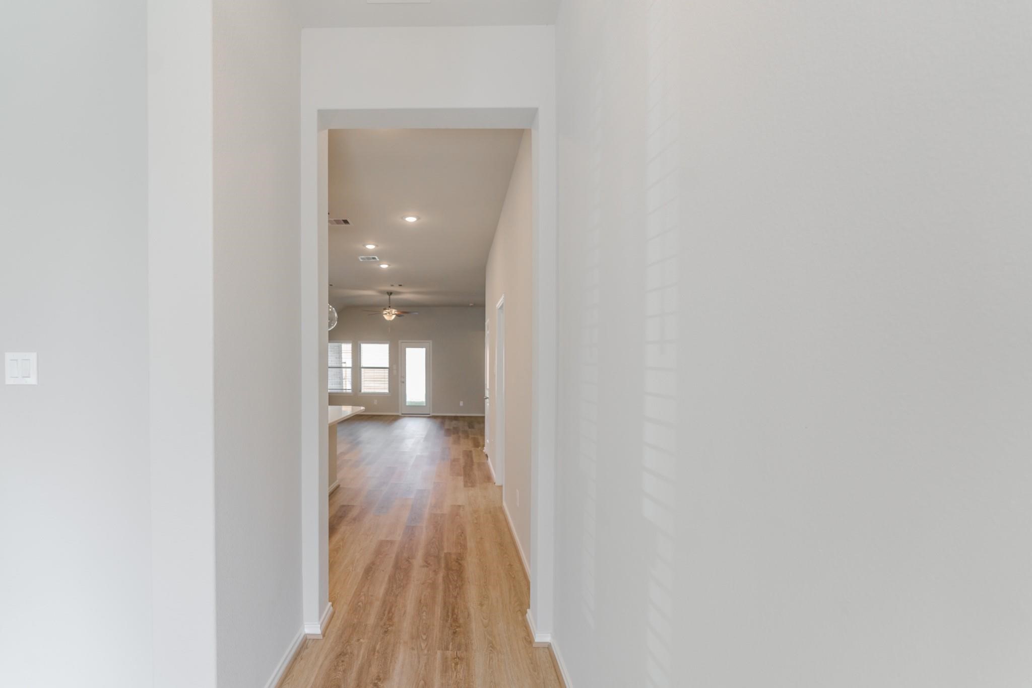 7427 Caprock Cyn Lane Porter, TX 77365 - Photo 2 of 21 a view of a hallway with wooden floor