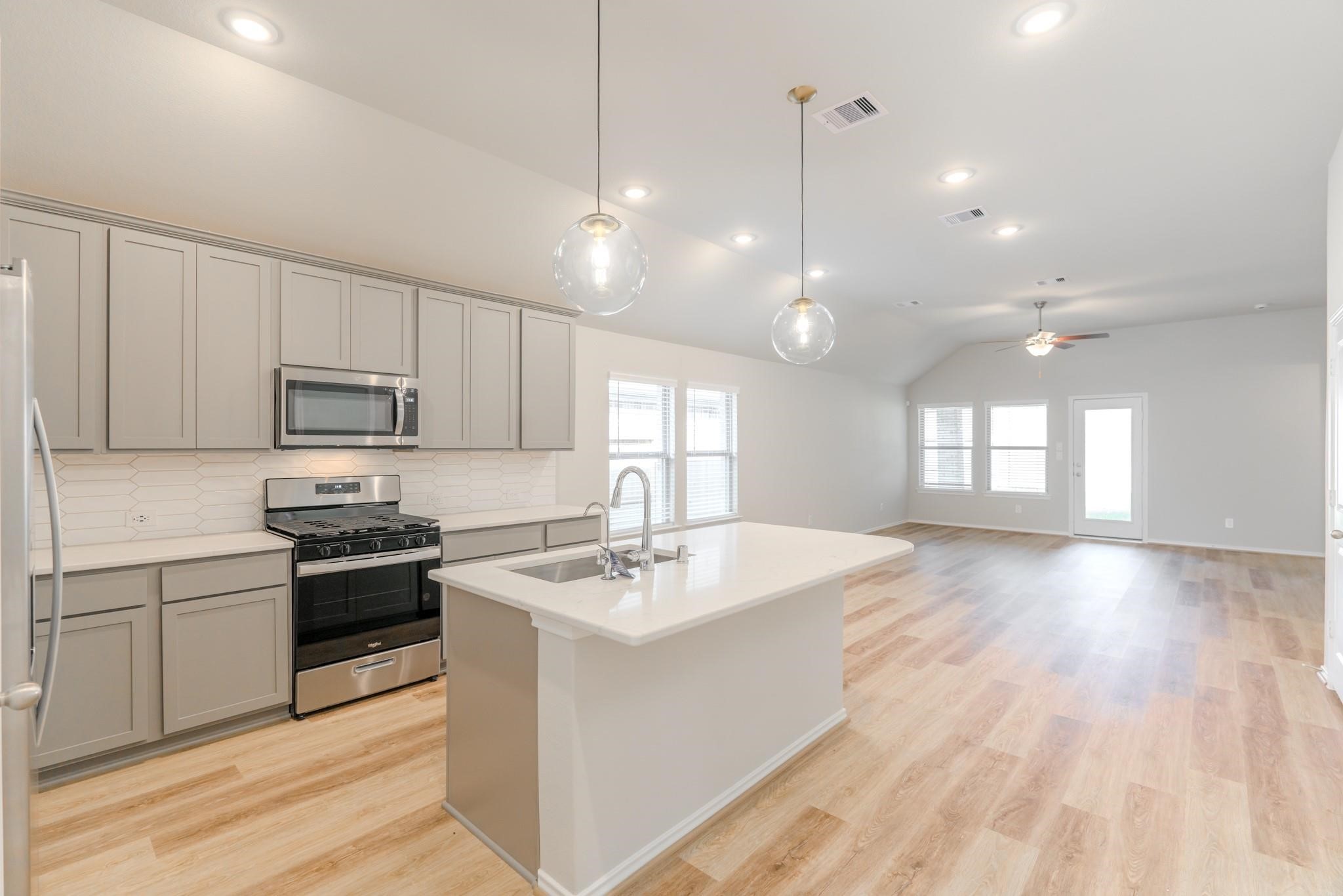 7427 Caprock Cyn Lane Porter, TX 77365 - Photo 5 of 21 a kitchen with a sink window and cabinets