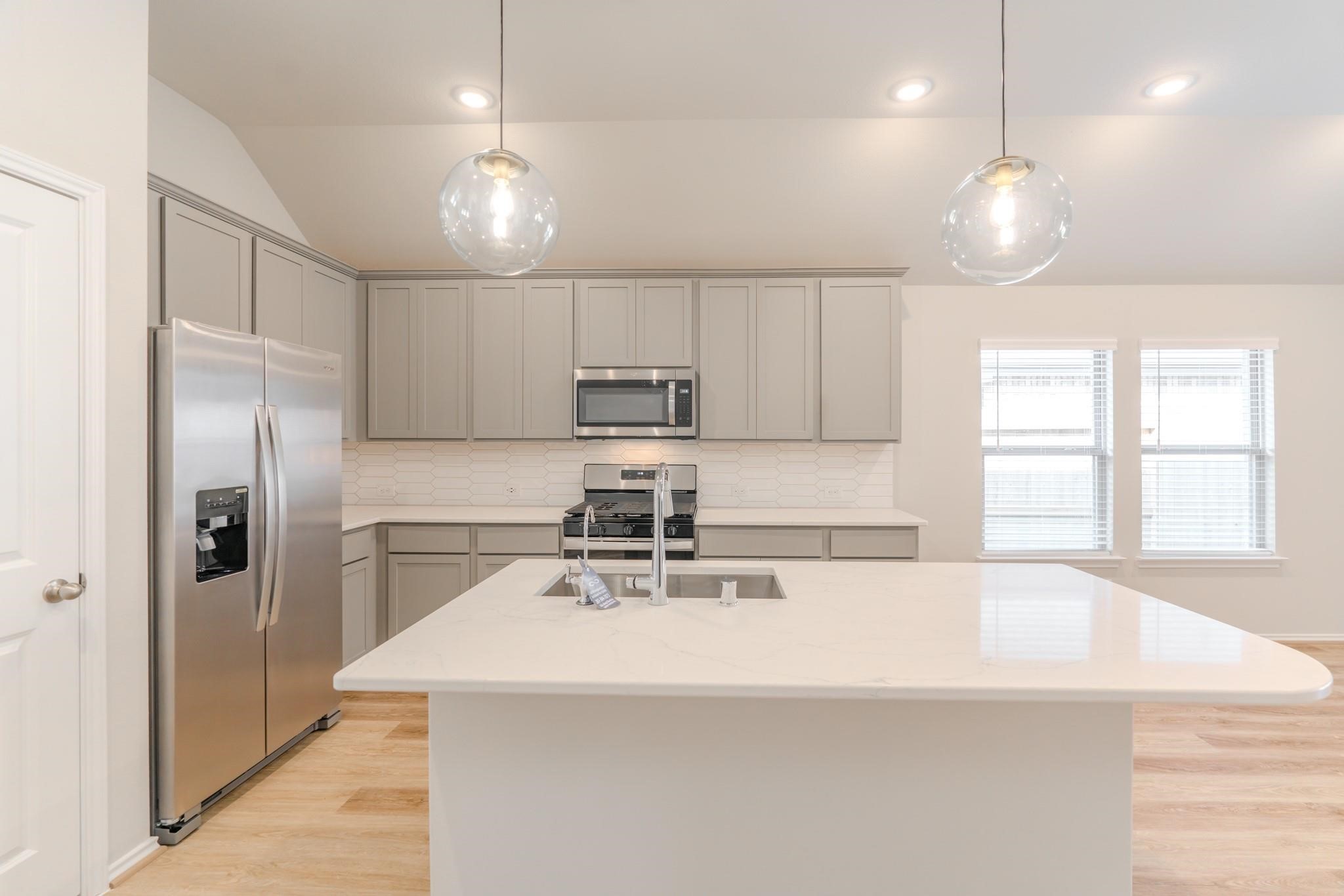 7427 Caprock Cyn Lane Porter, TX 77365 - Photo 6 of 21 a kitchen with kitchen island a sink stainless steel appliances and window