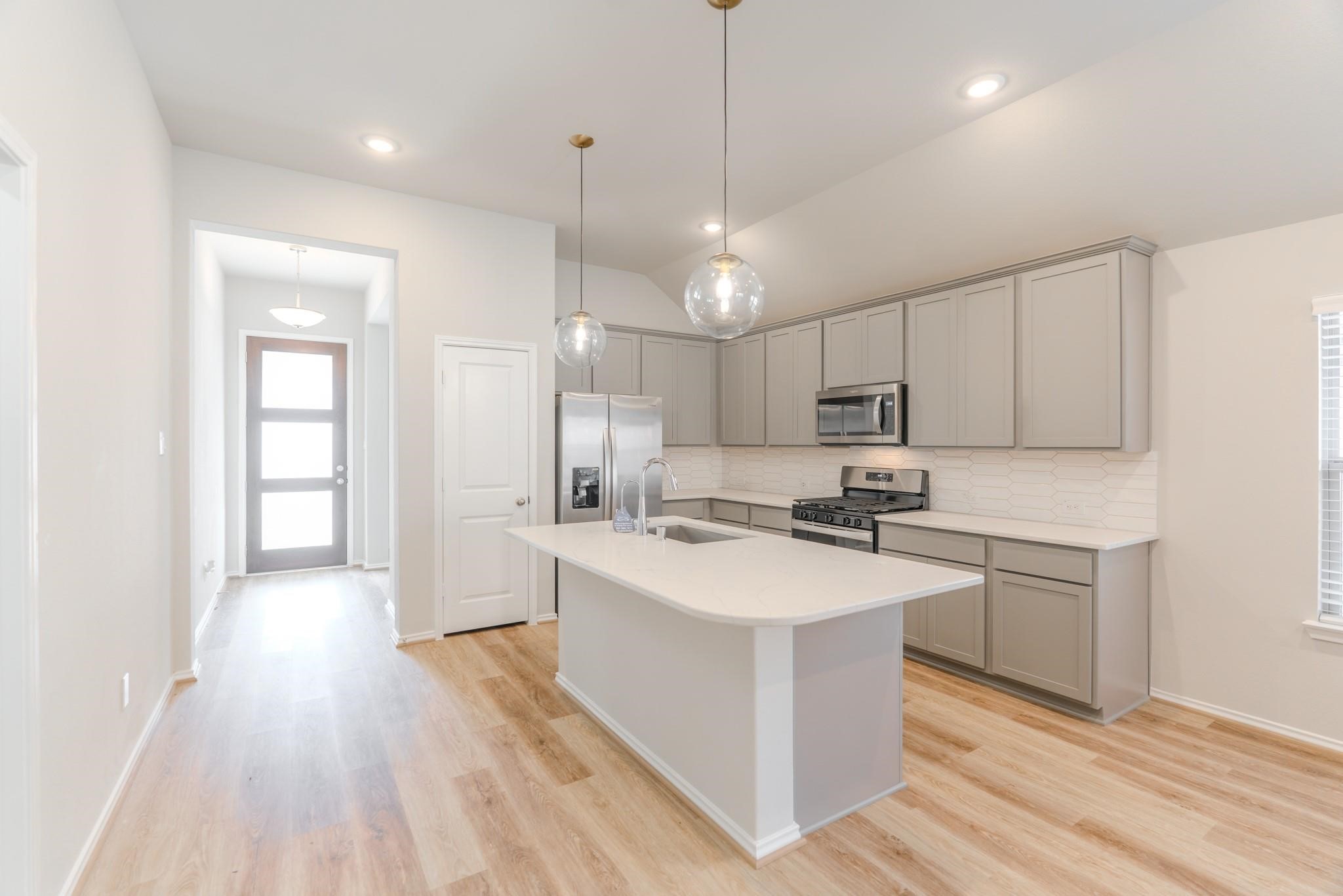 7427 Caprock Cyn Lane Porter, TX 77365 - Photo 7 of 21 a kitchen with stainless steel appliances granite countertop a sink a stove a refrigerator and island with wooden floor