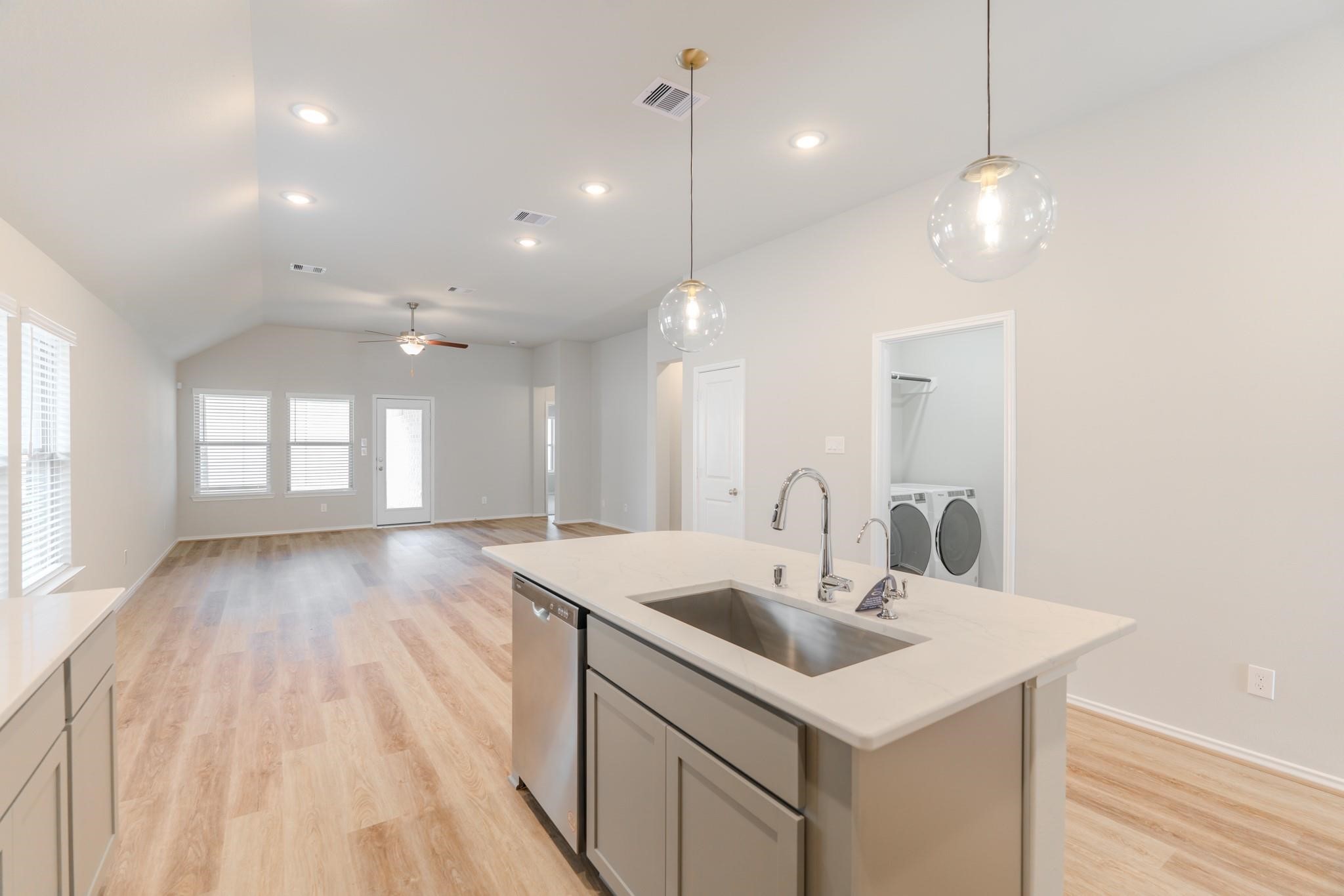 7427 Caprock Cyn Lane Porter, TX 77365 - Photo 9 of 21 a kitchen with a sink chandelier and wooden floor