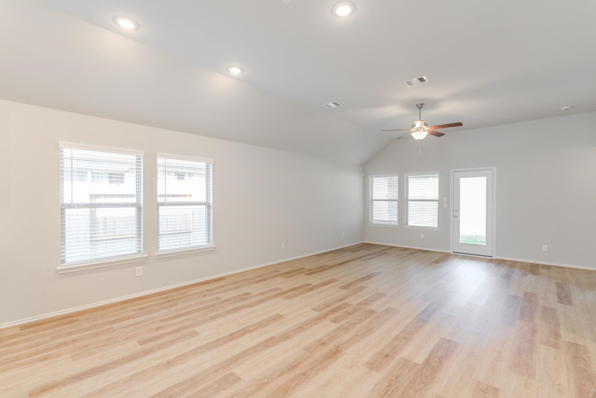 7427 Caprock Cyn Lane Porter, TX 77365 - Photo 10 of 21 an empty room with wooden floor and windows