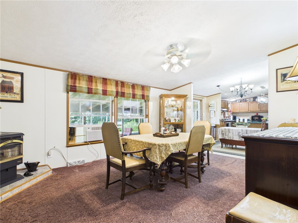 87 Collins Road Lewis Run, PA 16738 - Photo 10 of 48 Formal dining with pellet stove open to eat-in kit