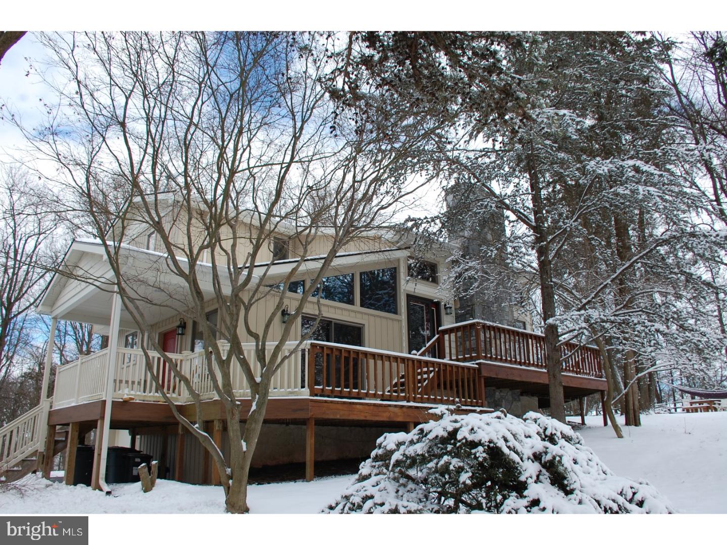 a view of a house with a yard covered in snow