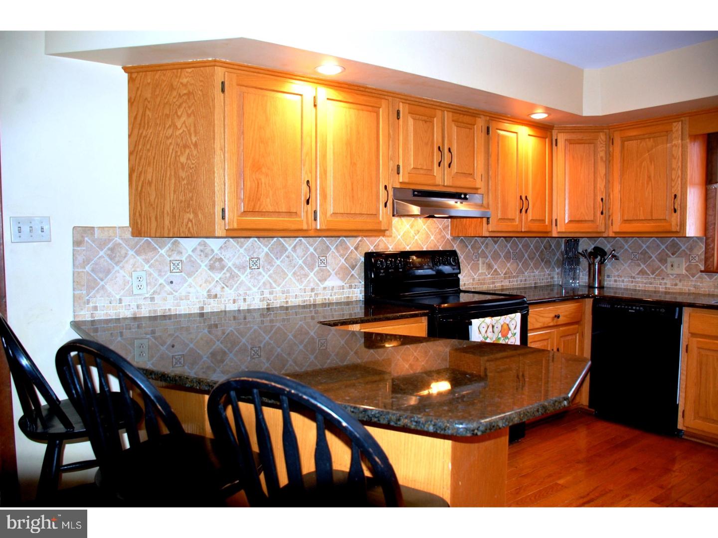 163 Mail Rte Road Sinking Spring, PA 19608 - Photo 11 of 25 a kitchen with granite countertop a stove a sink and a dining table