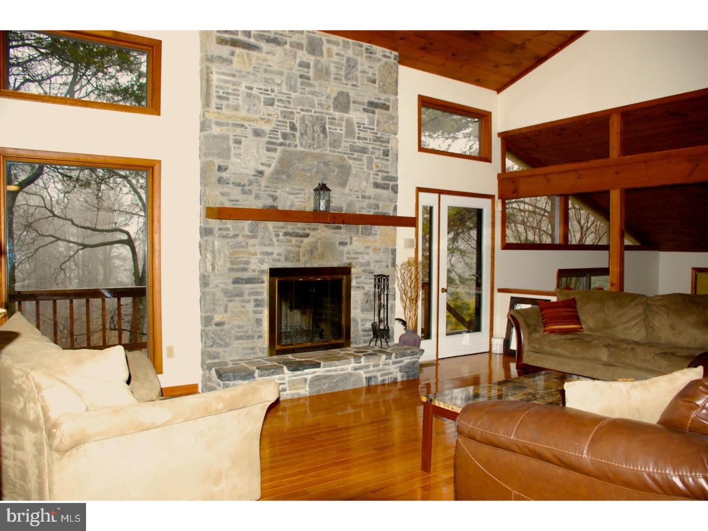 163 Mail Rte Road Sinking Spring, PA 19608 - Photo 16 of 25 a living room with furniture a flat screen tv and a fireplace